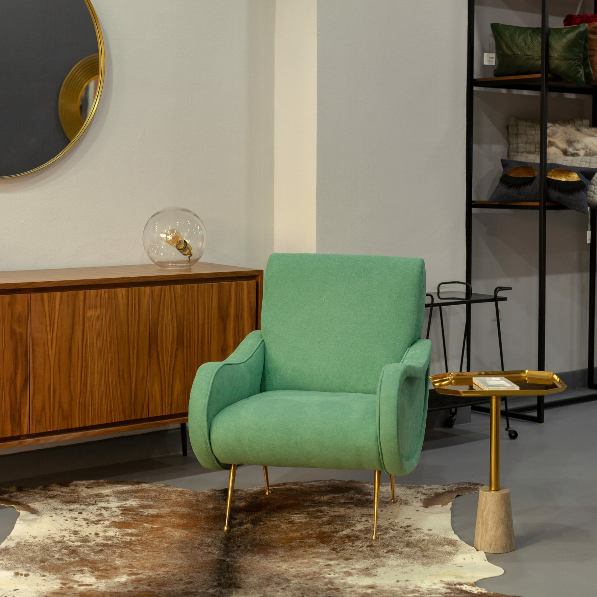 Une chaise verte dans une pièce avec un tapis en peau de vache.