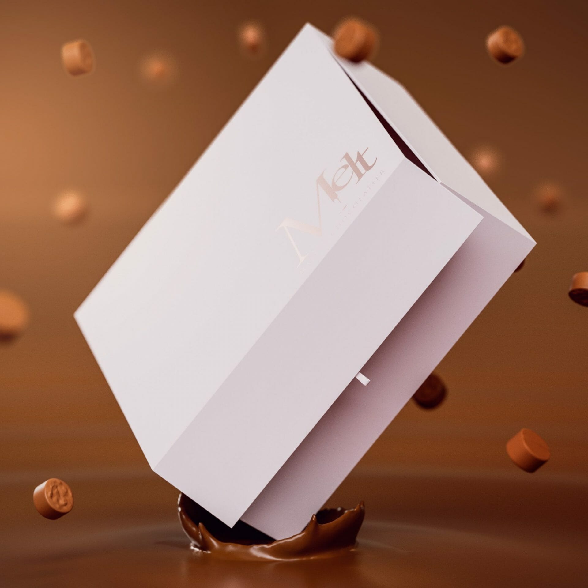 Une boîte blanche avec des chocolats qui en tombe.